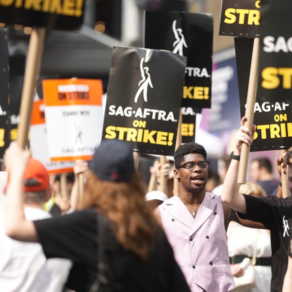 Actors and writers on strike are united and determined in the face of a long summer standoff | AP News