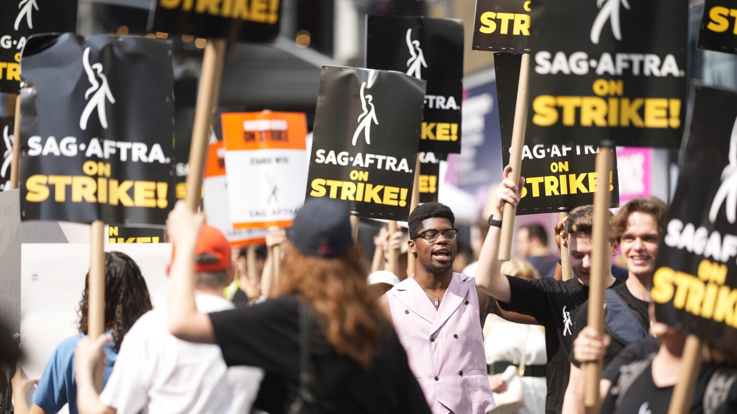 Actors and writers on strike are united and determined in the face of a long summer standoff | AP News