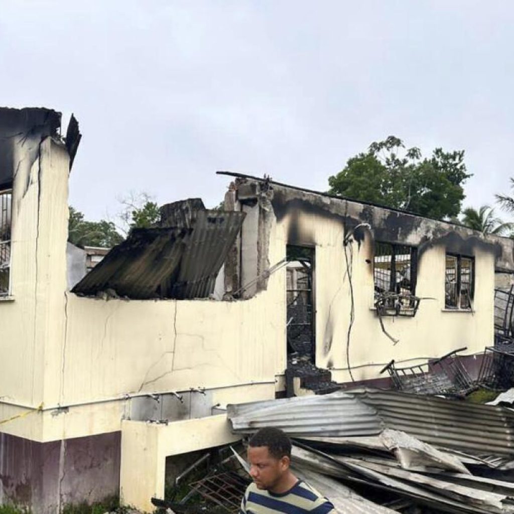 Guyana government reaches settlement with parents in dormitory fire that killed 20 children | AP News