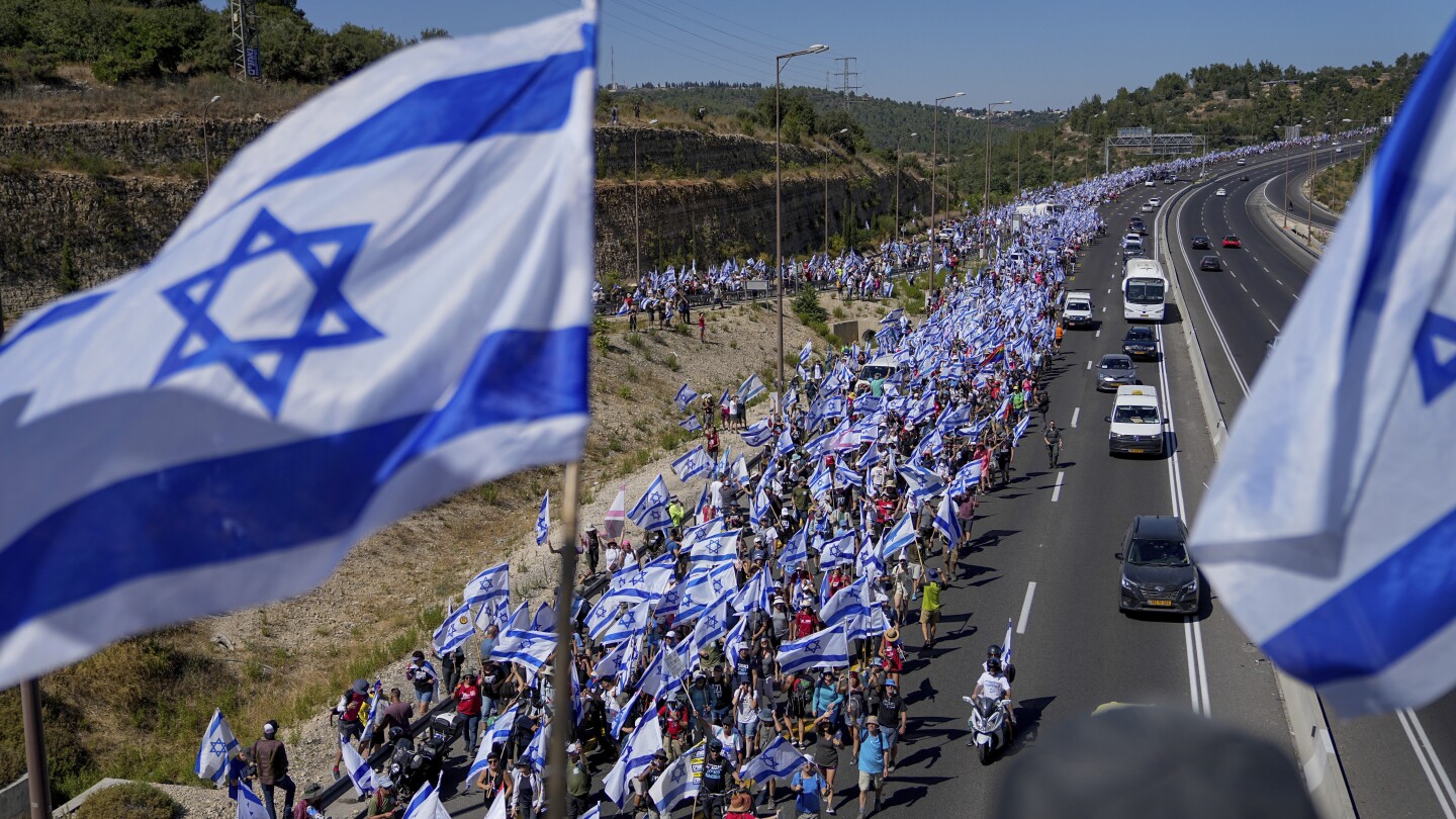 Hundreds of thousands march in Israel. Former security chiefs beg Netanyahu to halt legal overhaul | AP News