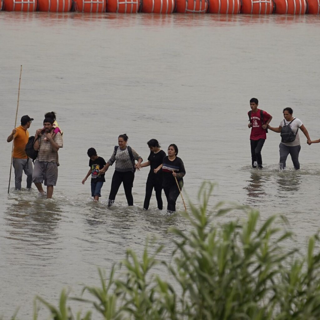 Biden administration sues Texas governor over Rio Grande buoy barrier that’s meant to stop migrants | AP News