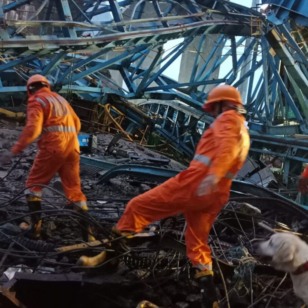 14 workers killed in the collapse of a crane being used to build a bridge in India | AP News