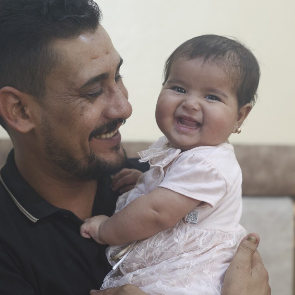 Syrian baby born under earthquake rubble turns 6 months, happily surrounded by her adopted family | AP News