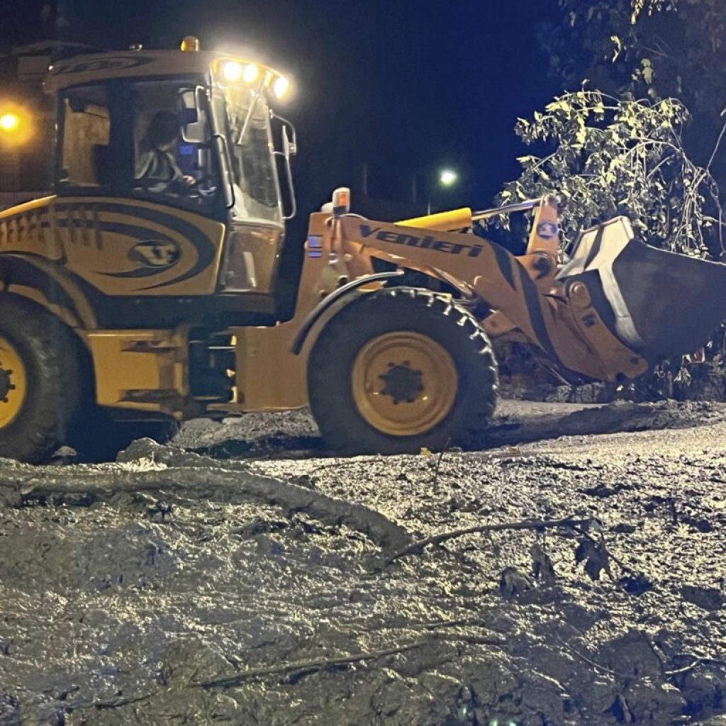 Crews search for possible missing after a mudslide in the Italian Alps coats city streets in muck | AP News