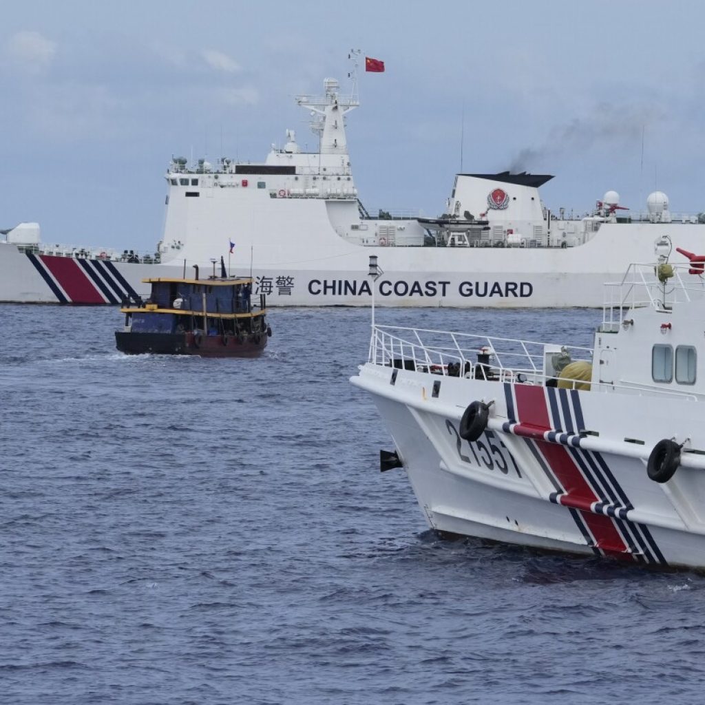 Chinese coast guard blocks Philippine vessels near disputed shoal but two supply boats breach cordon | AP News