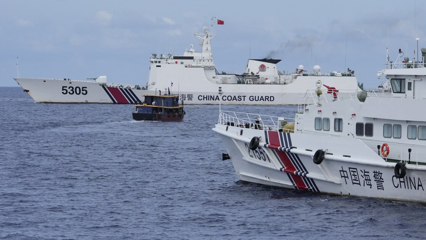 Chinese coast guard blocks Philippine vessels near disputed shoal but two supply boats breach cordon | AP News