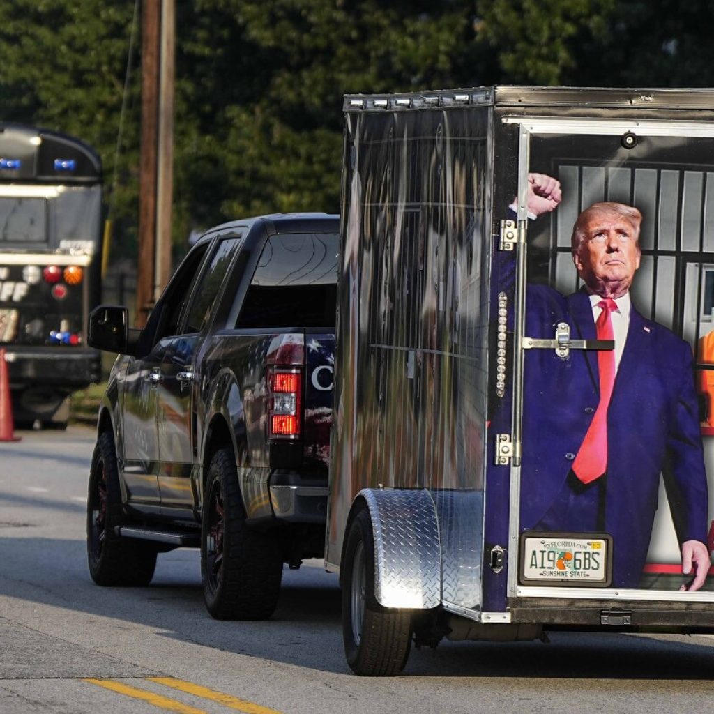 Scores of Trump supporters show support outside Georgia jail ahead of his expected surrender | AP News