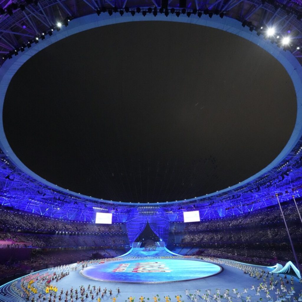 Lots of dignitaries but no real fireworks — only electronic flash — as the Asian Games open | AP News