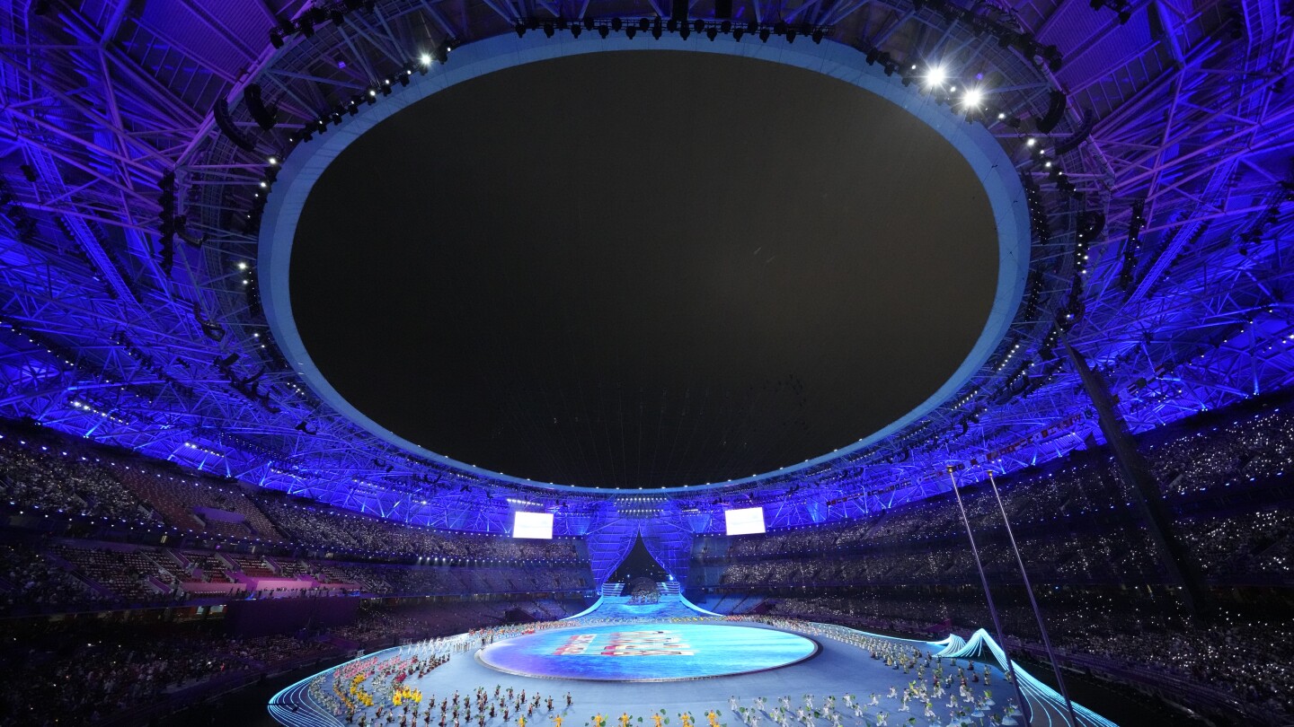 Lots of dignitaries but no real fireworks — only electronic flash — as the Asian Games open | AP News