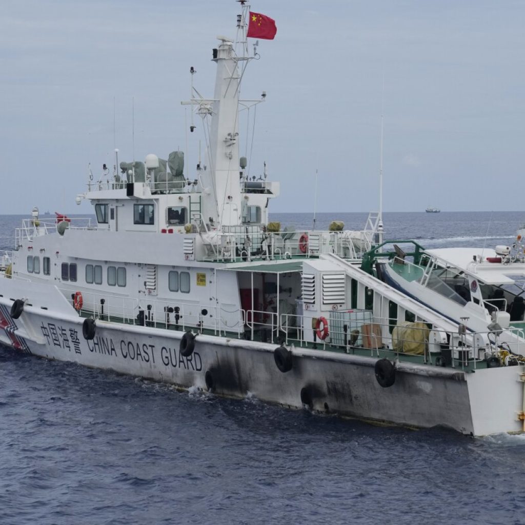 Philippines vows to remove floating barrier placed by China’s coast guard at a disputed lagoon | AP News