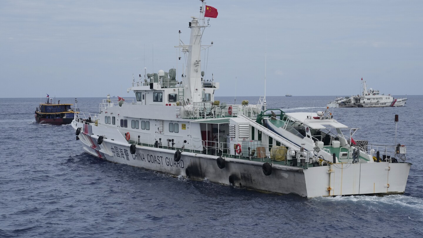 Philippines vows to remove floating barrier placed by China’s coast guard at a disputed lagoon | AP News