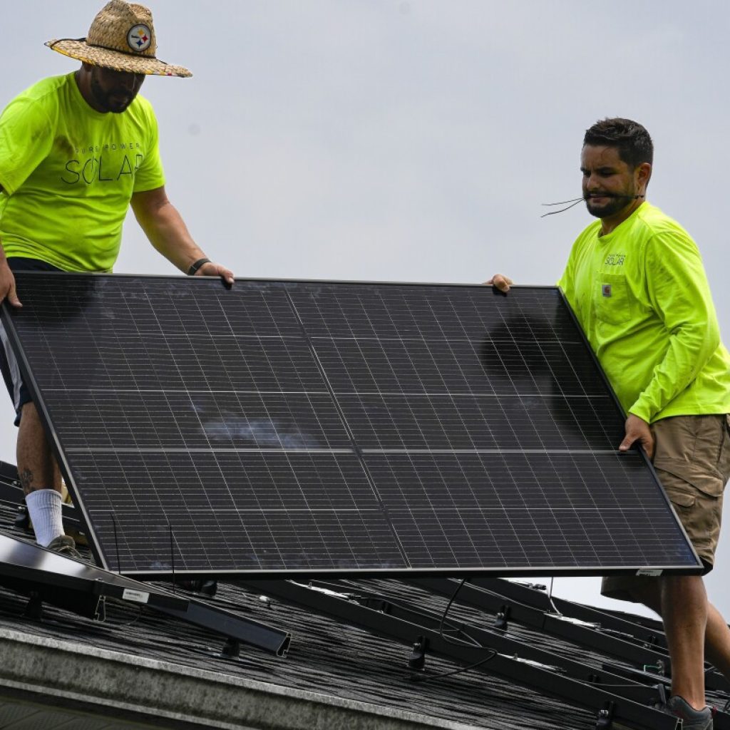 Boost in solar energy and electric vehicle sales gives hope for climate goals, report says | AP News