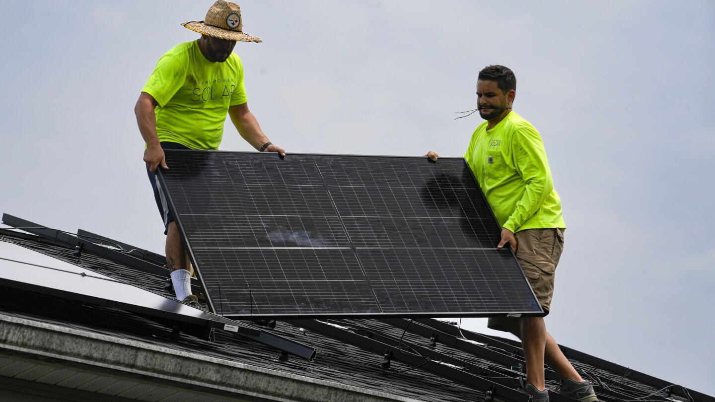 Boost in solar energy and electric vehicle sales gives hope for climate goals, report says | AP News