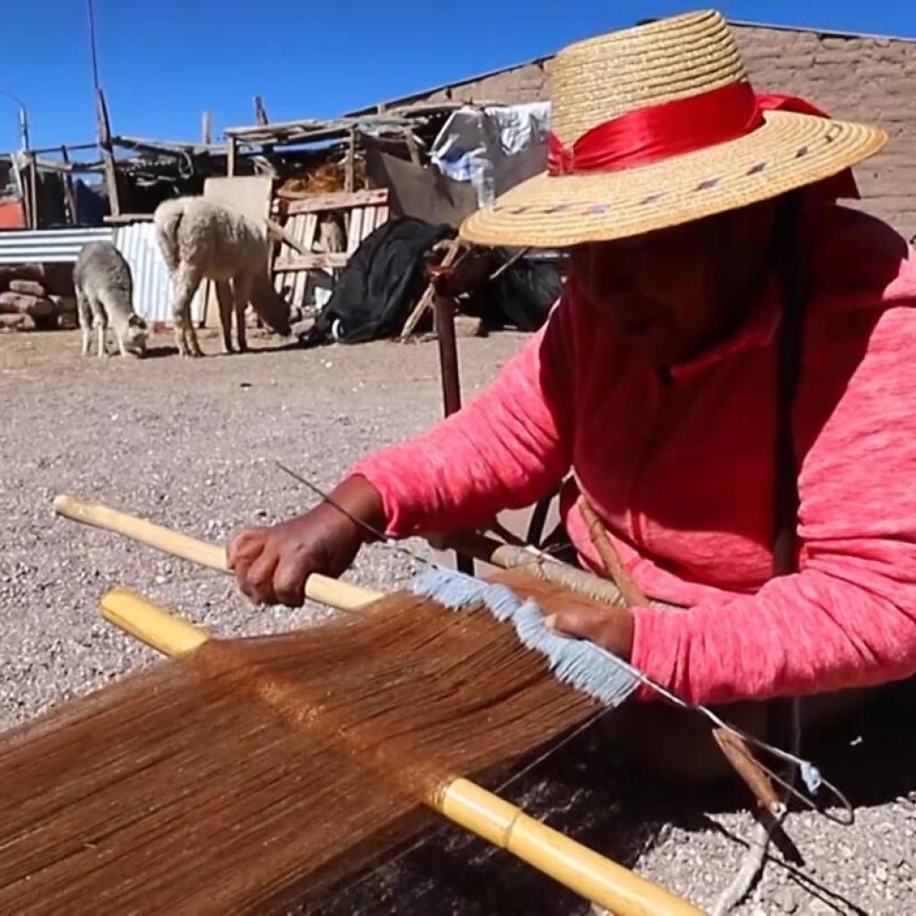 Inspired by llamas, the desert and Mother Earth, these craftswomen weave sacred textiles | AP News