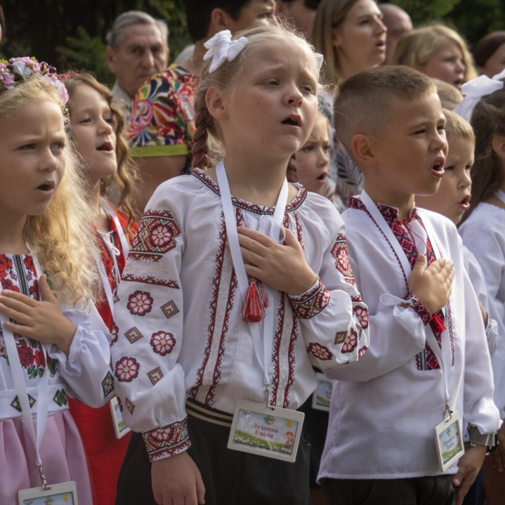 It’s joy mixed with sorrow as Ukrainian children go back to school in the midst of war | AP News