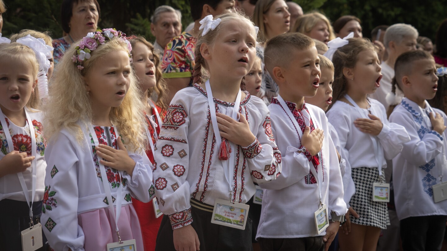 It’s joy mixed with sorrow as Ukrainian children go back to school in the midst of war | AP News