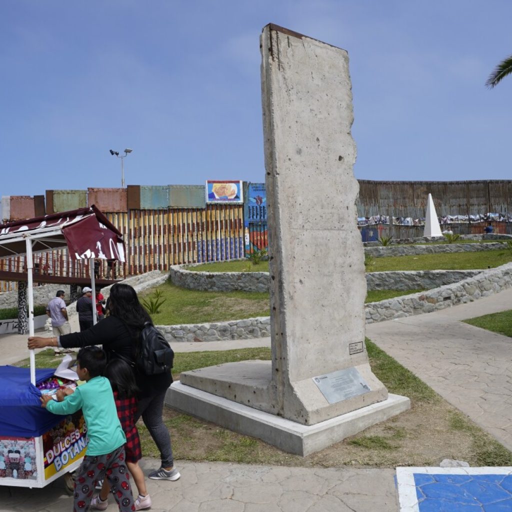 Berlin Wall relic gets a ‘second life’ on US-Mexico border as Biden adds barriers | AP News