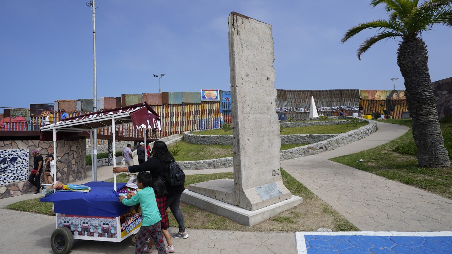 Berlin Wall relic gets a ‘second life’ on US-Mexico border as Biden adds barriers | AP News