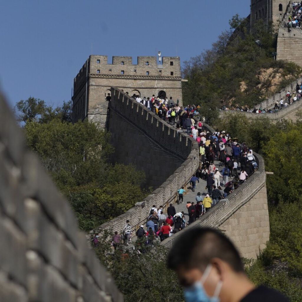 China authorities arrest 2 for smashing shortcut through Great Wall with excavator | AP News