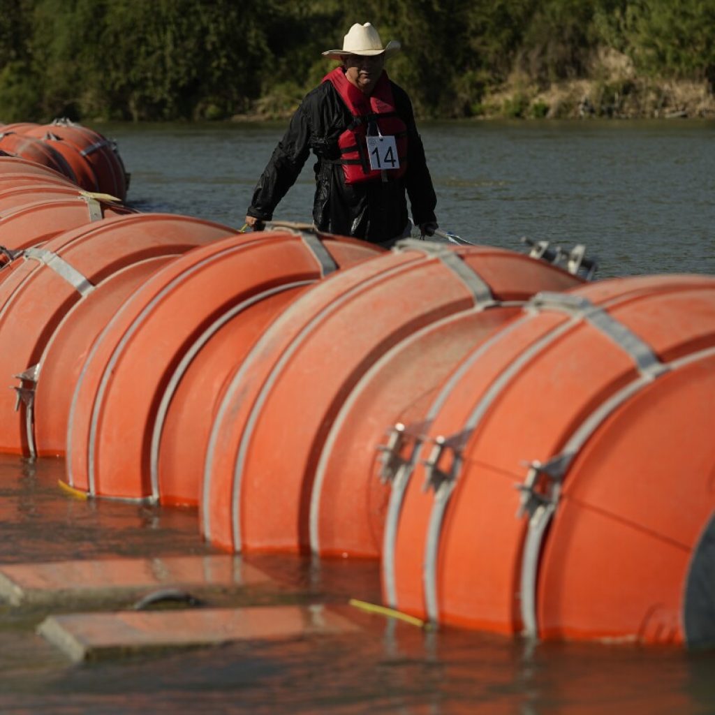 A judge orders Texas to move a floating barrier used to deter migrants to the bank of the Rio Grande | AP News