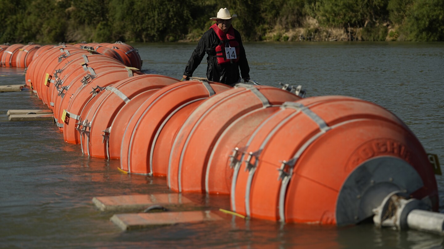 A judge orders Texas to move a floating barrier used to deter migrants to the bank of the Rio Grande | AP News