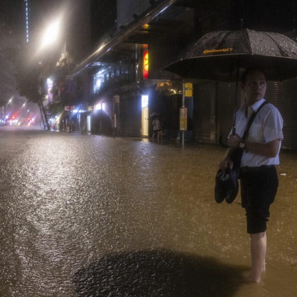 Hong Kong closes schools as torrential rain floods streets, subway station | AP News