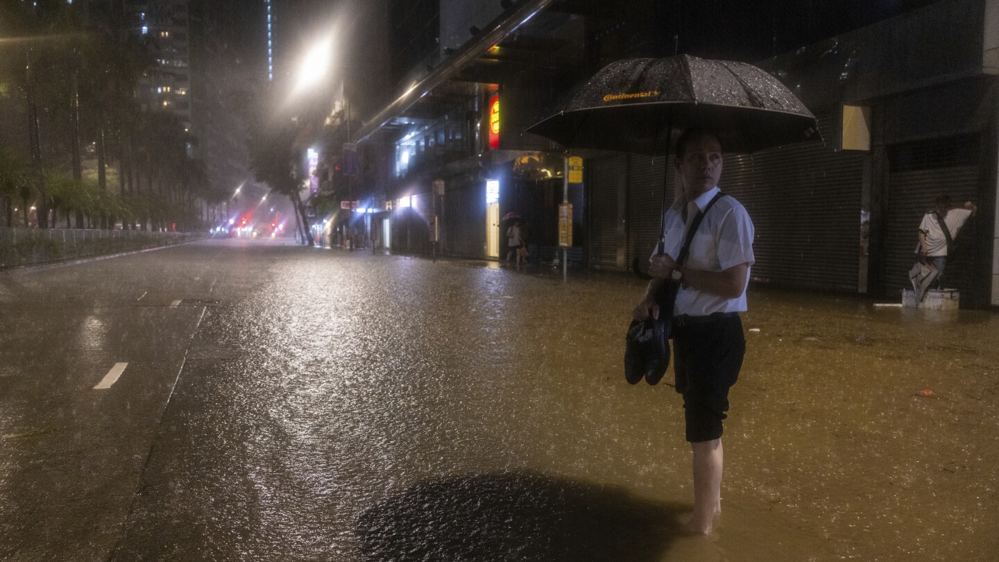 Hong Kong closes schools as torrential rain floods streets, subway station | AP News