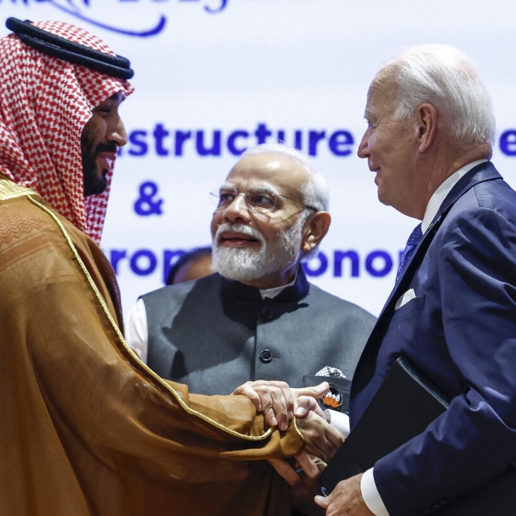 Biden gives Saudi Crown Prince Mohammed a hearty handshake a year after an awkward fist bump moment | AP News