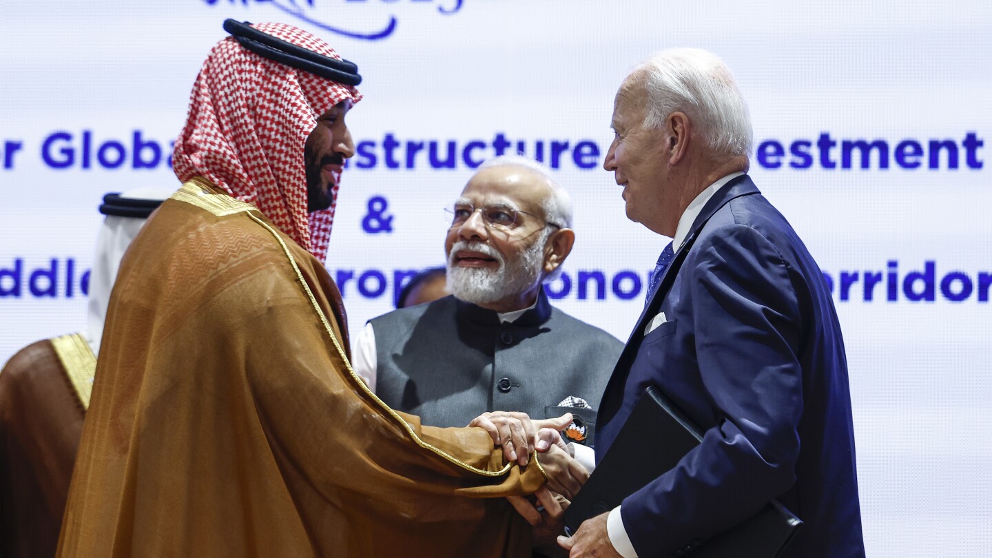 Biden gives Saudi Crown Prince Mohammed a hearty handshake a year after an awkward fist bump moment | AP News