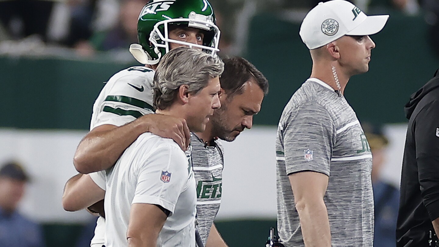 Aaron Rodgers injures ankle in debut with the New York Jets | AP News