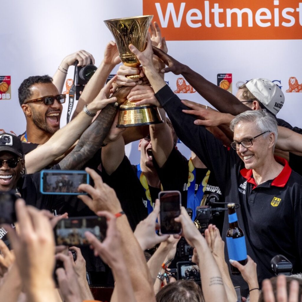 Fans cheer German basketball team’s return home after winning World Cup title | AP News