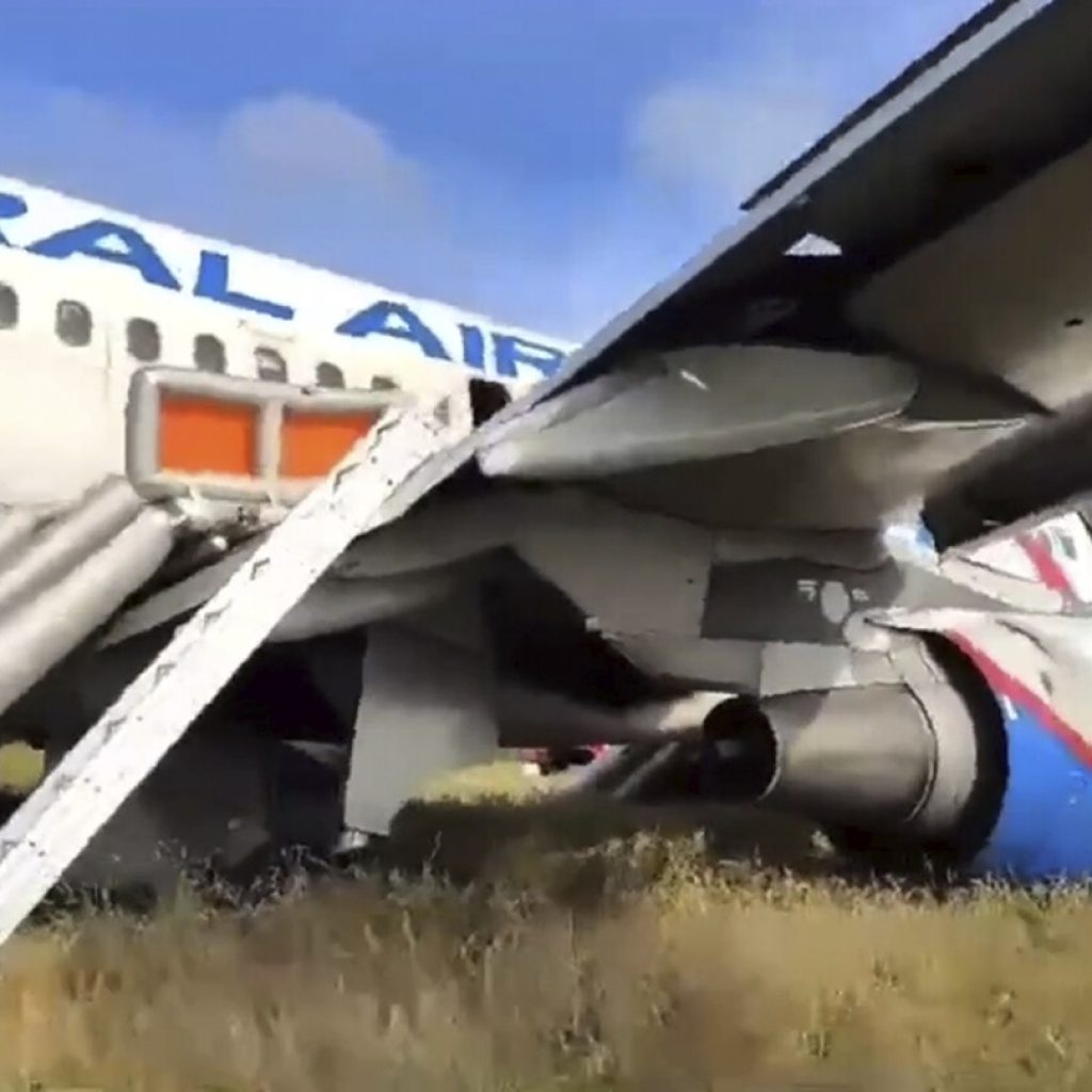 A Russian passenger jet with a hydraulics problem makes a safe emergency landing in an open field | AP News