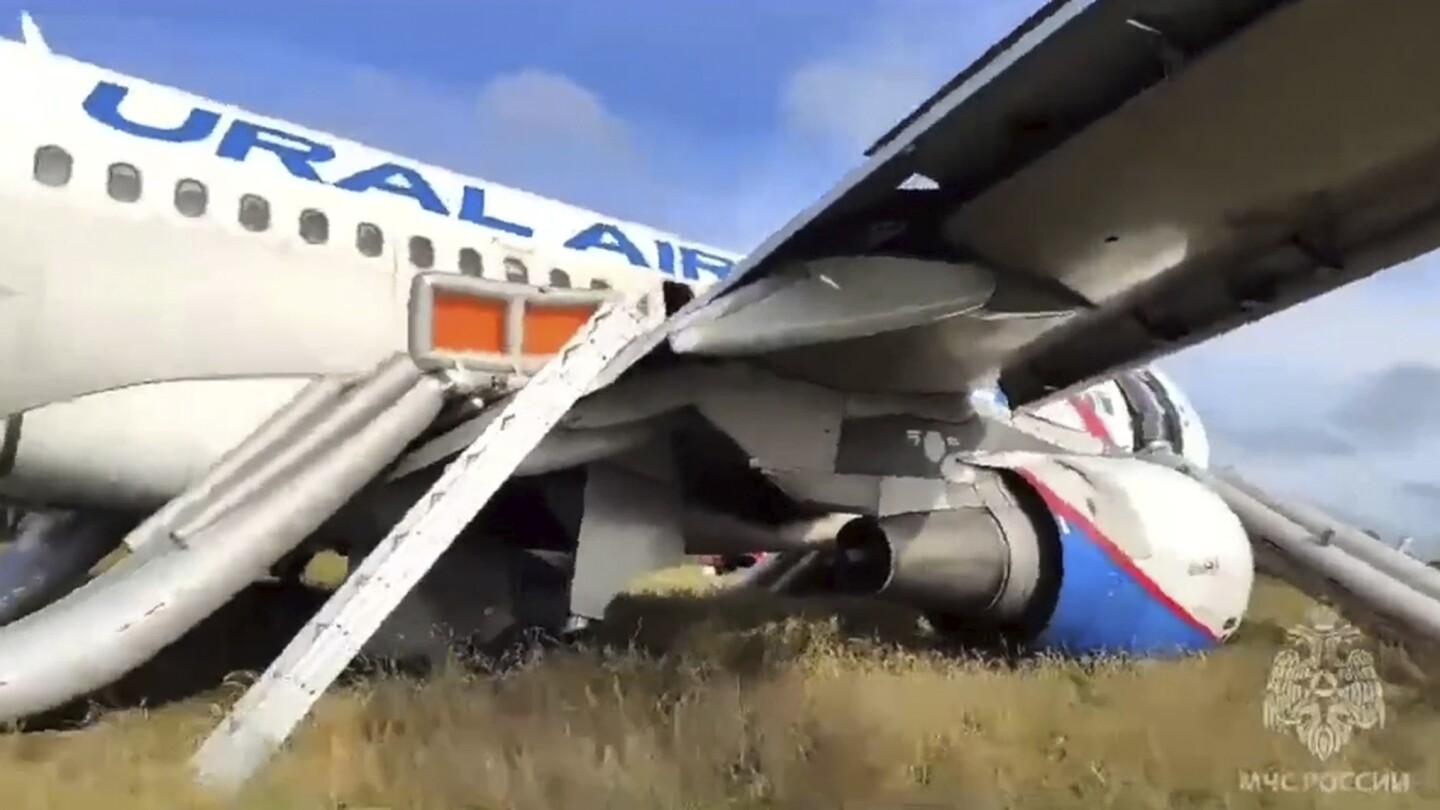 A Russian passenger jet with a hydraulics problem makes a safe emergency landing in an open field | AP News