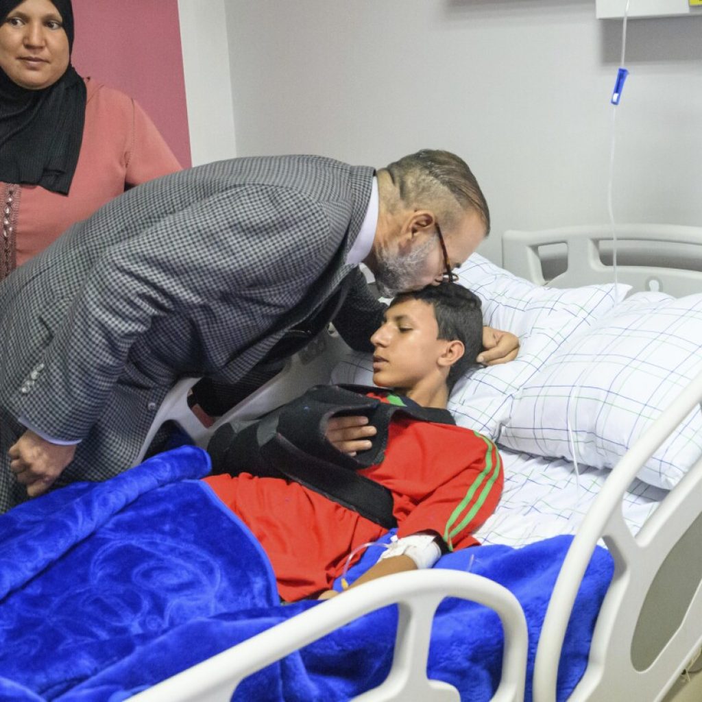 King of Morocco visits earthquake patients at Marrakech, kissing one on head and donating blood | AP News