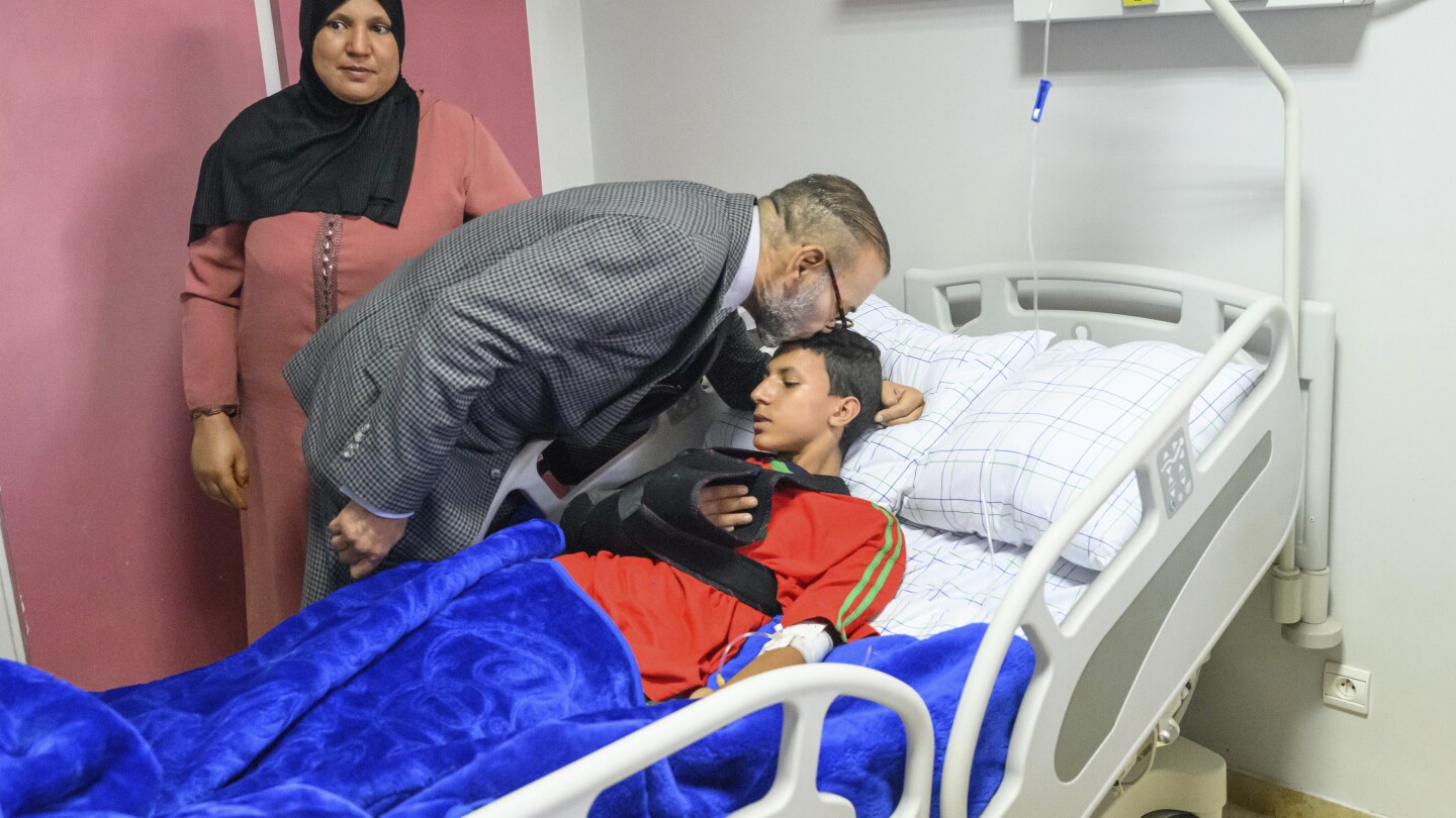 King of Morocco visits earthquake patients at Marrakech, kissing one on head and donating blood | AP News