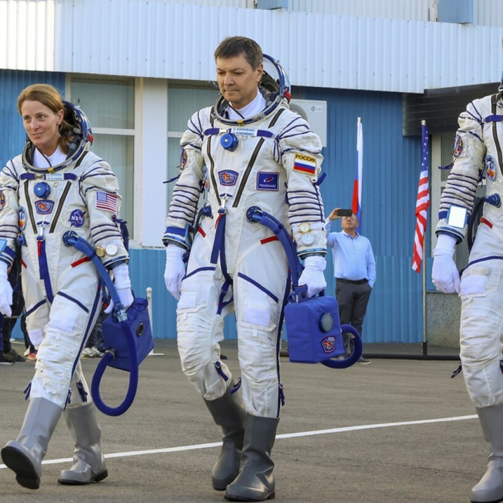 One American, two Russians ride Russian capsule to the International Space Station | AP News