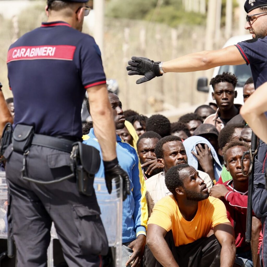 Top EU official heads to an Italian island struggling with migrant influx as Italy toughens stance | AP News