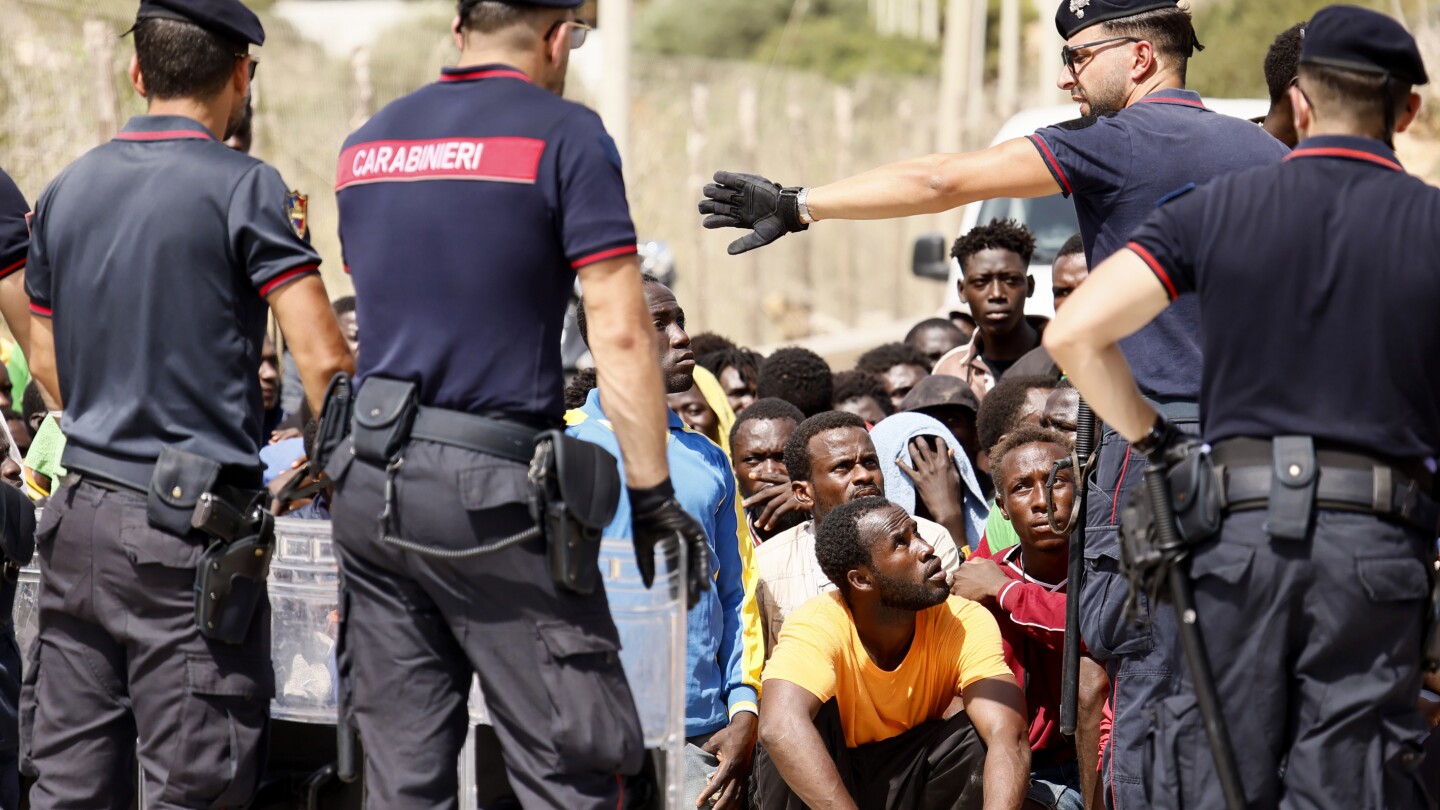 Top EU official heads to an Italian island struggling with migrant influx as Italy toughens stance | AP News