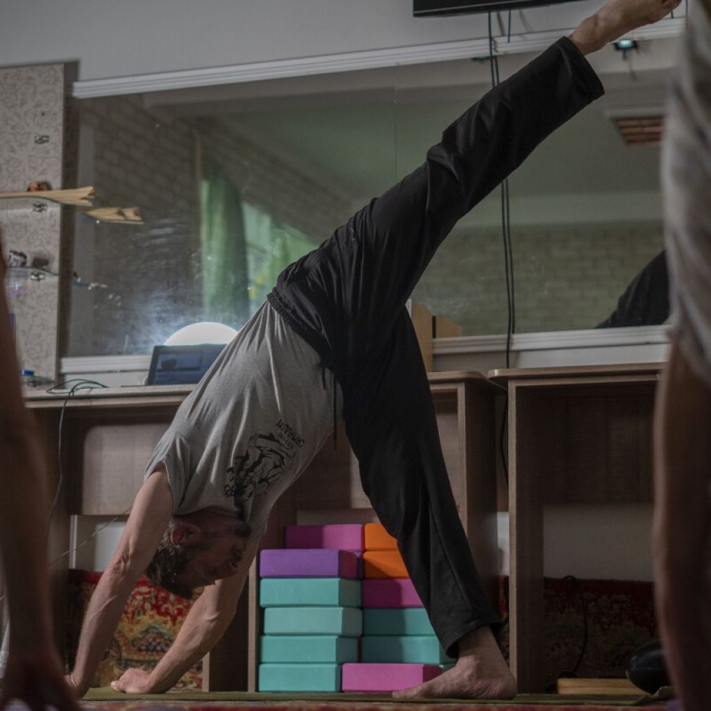 Yoga in a basement helps people in a Ukrainian front-line city cope with Russia’s constant shelling | AP News