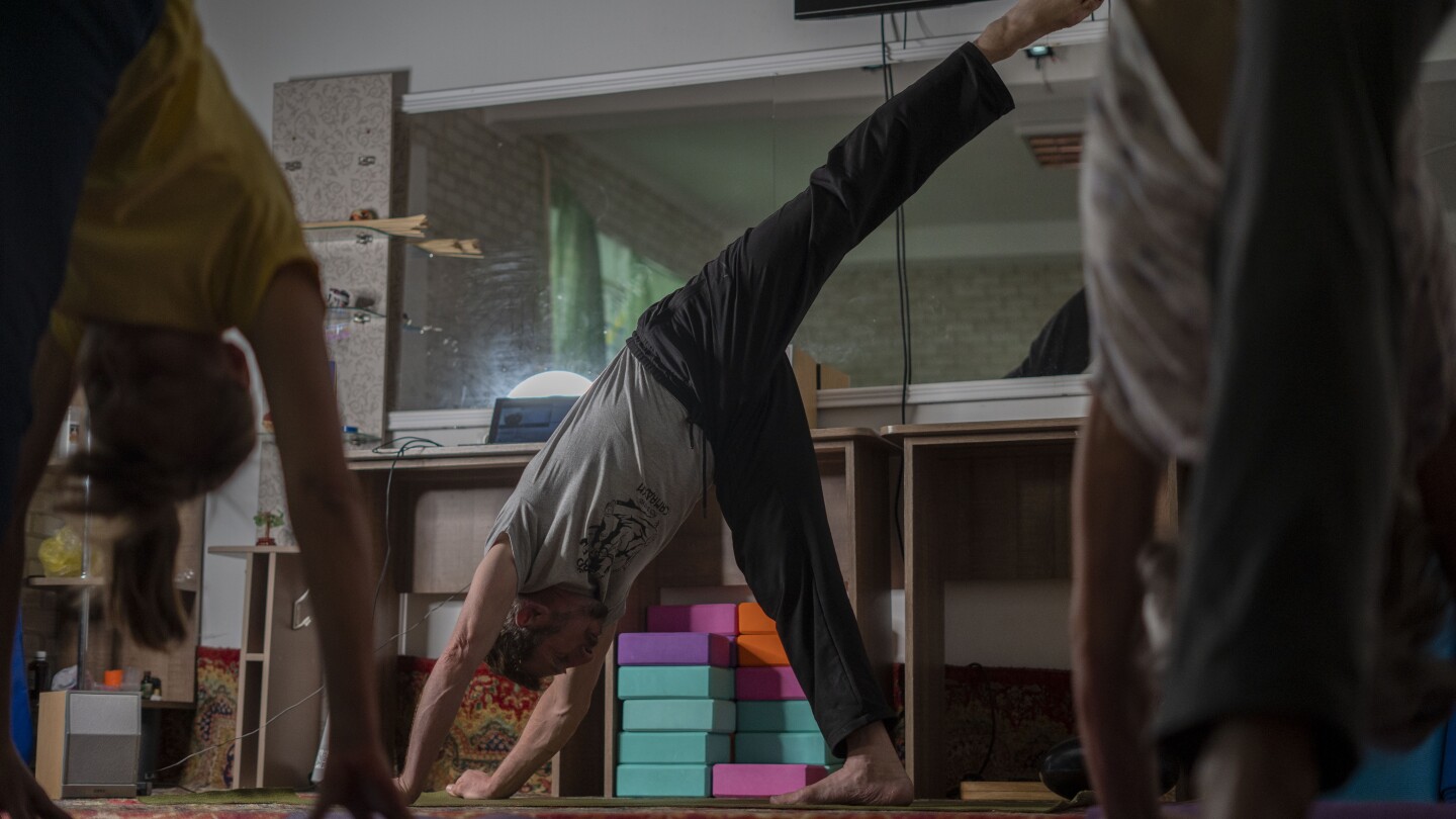 Yoga in a basement helps people in a Ukrainian front-line city cope with Russia’s constant shelling | AP News