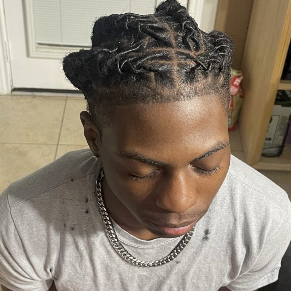 A Black student was suspended for his hairstyle. The school says it wasn’t discrimination | AP News