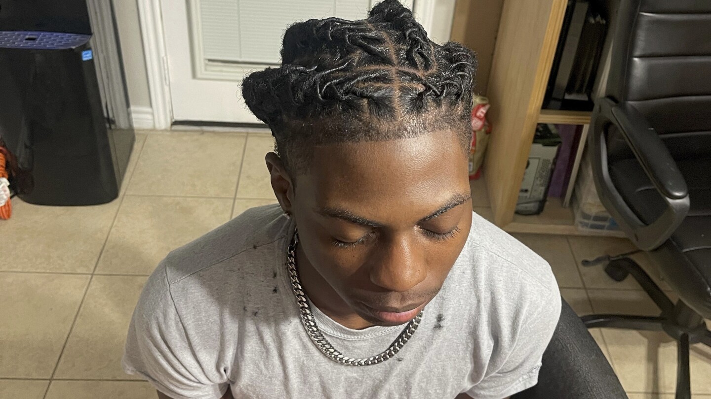 A Black student was suspended for his hairstyle. The school says it wasn’t discrimination | AP News