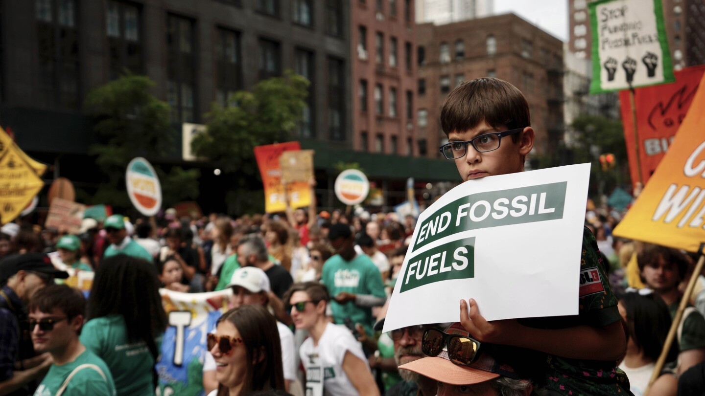 Tens of thousands march to kick off climate summit, demanding end to warming-causing fossil fuels | AP News