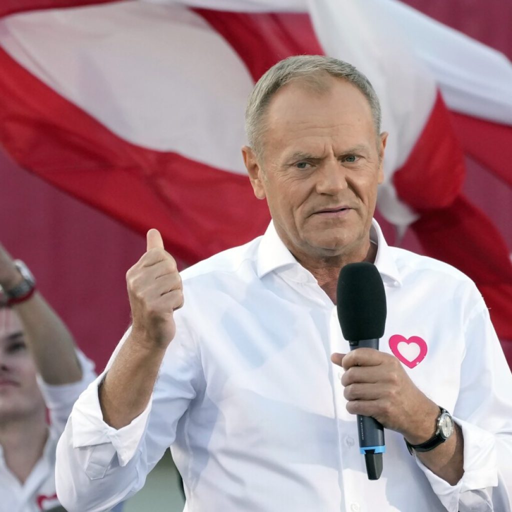 Polish opposition head Donald Tusk leads march to boost chances to unseat conservatives in election | AP News