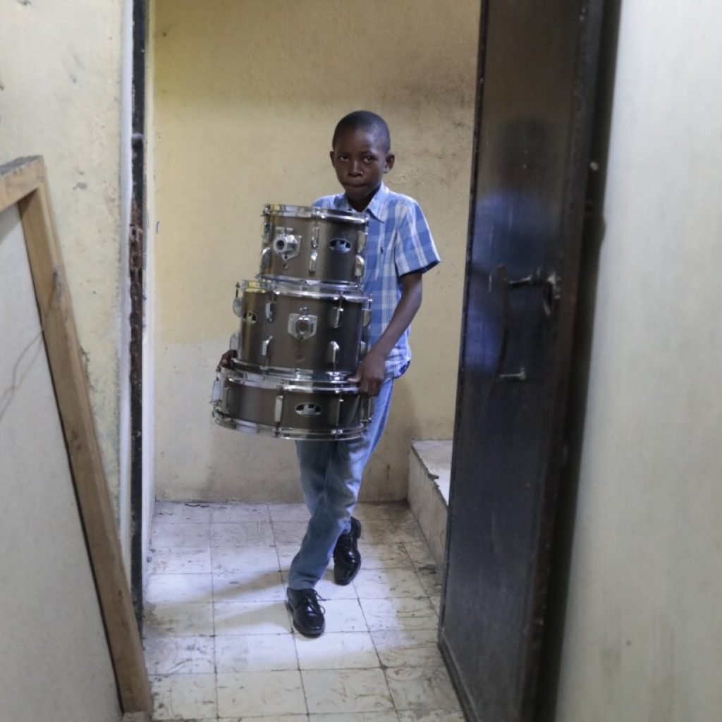 Haitian students play drums and strum guitars to escape hunger and gang violence | AP News