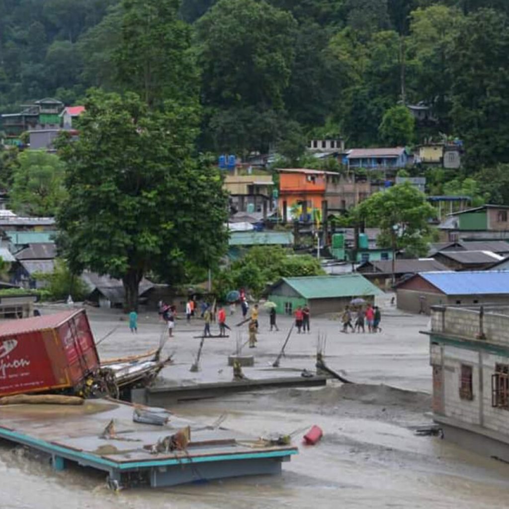 Flash floods kill at least 14 in northeastern India and leave more than 100 missing | AP News