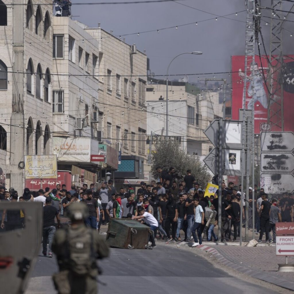 Palestinians march at youth’s funeral procession after settler rampage in flashpoint West Bank town | AP News