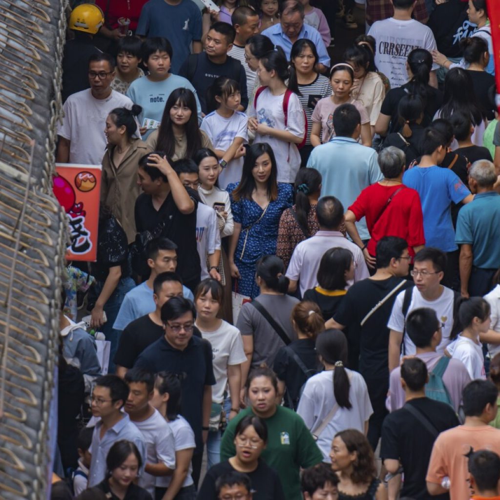 China’s flagging economy gets a temporary boost as holiday travel returns to pre-pandemic levels | AP News