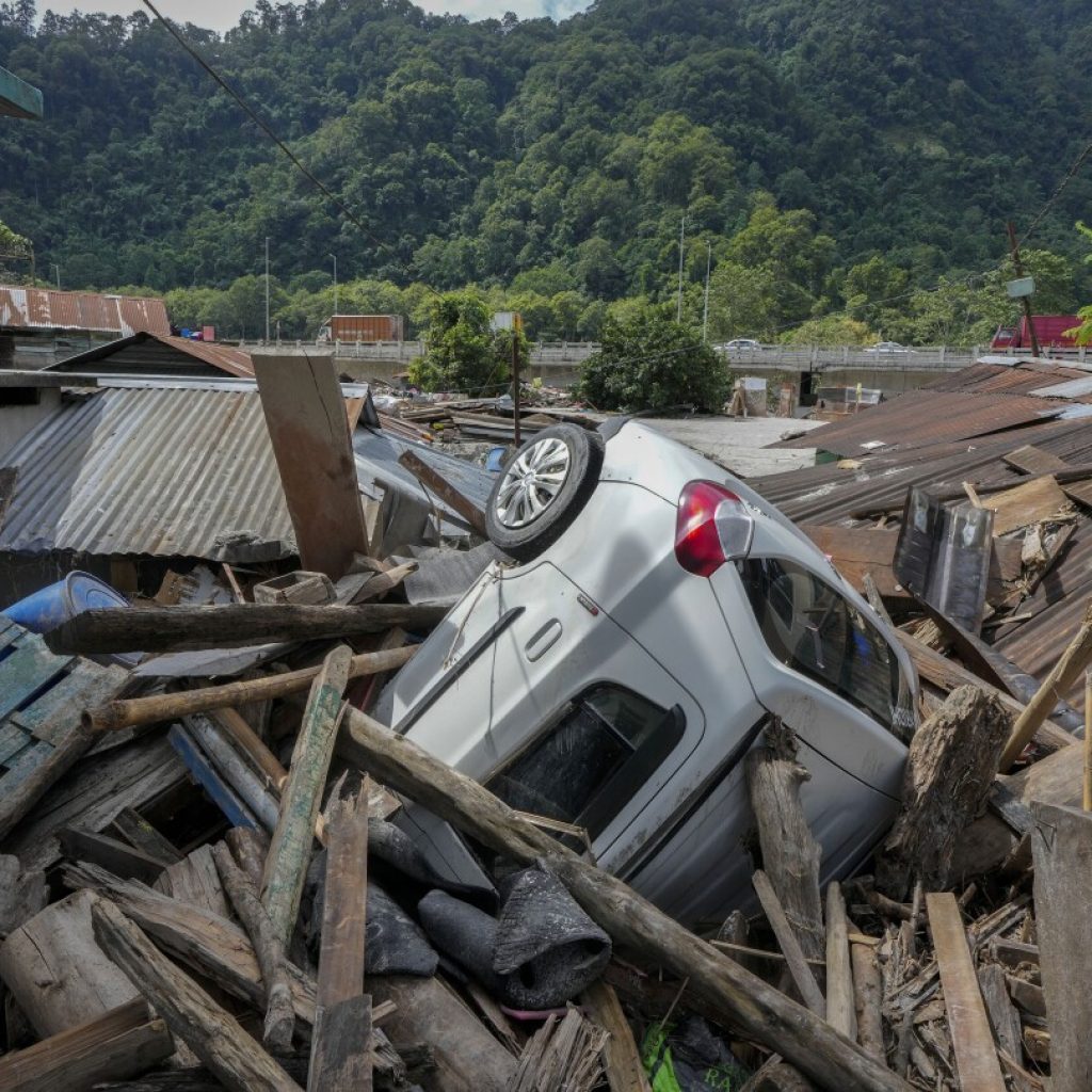 Indian rescue copters are flying into region where flood washed out bridges and killed at least 52 | AP News