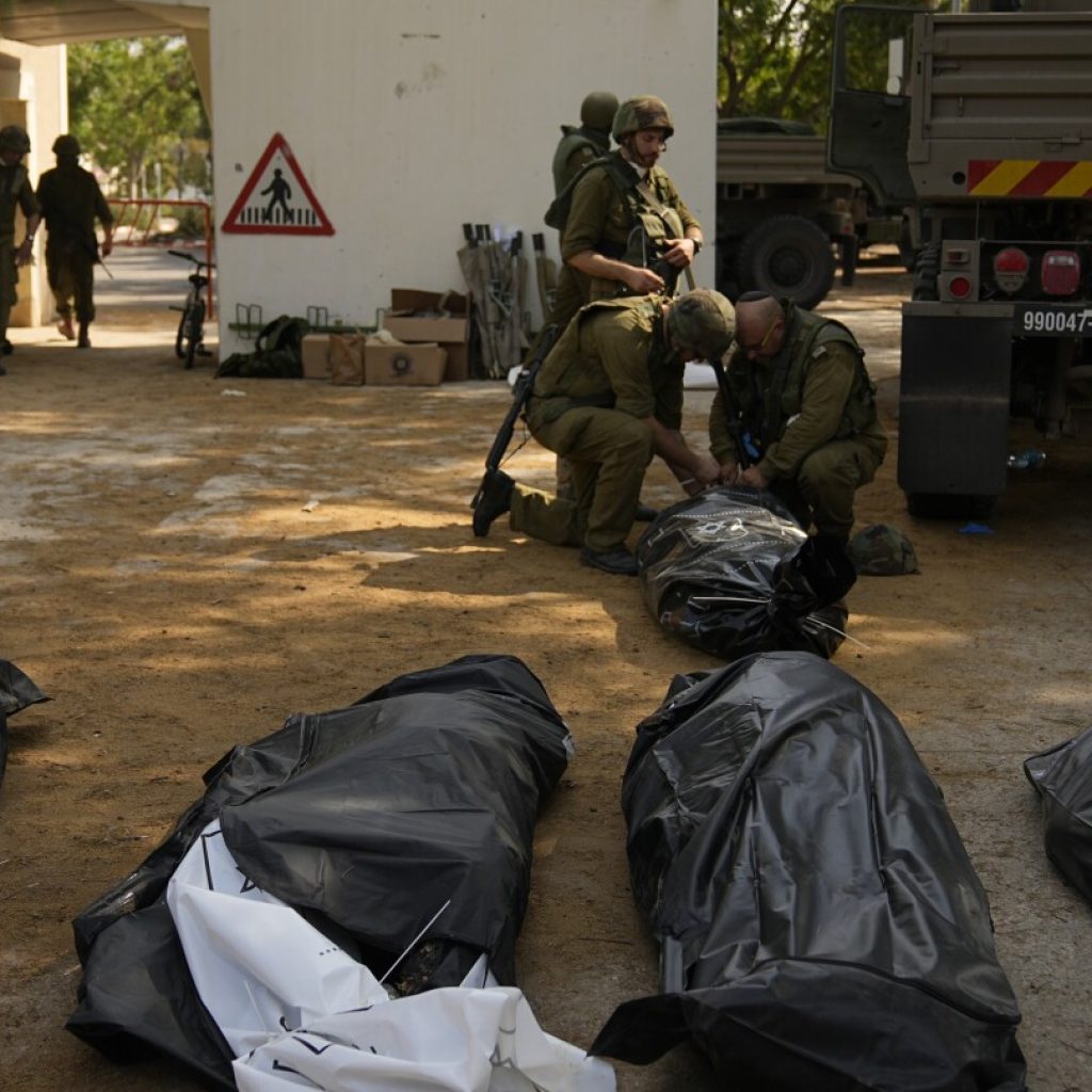 Israeli village near the Gaza border lies in ruin, filled with the bodies of residents and militants | AP News